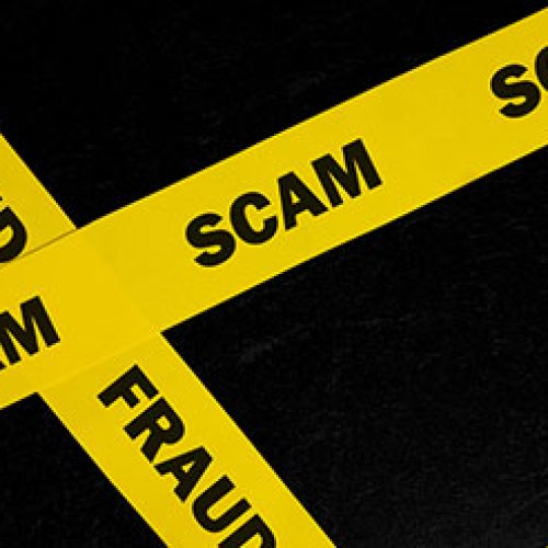 Yellow tape with scam and fraud text
